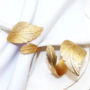 Gold metal leaf napkin ring detail showing texture, elegant table setting prop for restaurant.