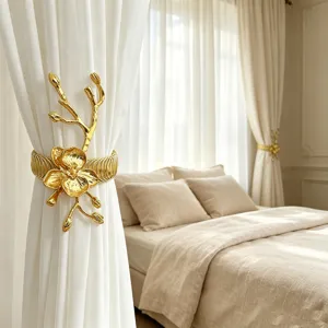 Gold orchid curtain tieback detail shot, luxury metal spring curtain buckle holder for home.