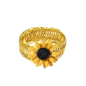 Gold metal curtain tieback detail featuring an attractive yellow sunflower design for home decor.
