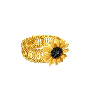 Golden metal spring curtain tieback featuring a vibrant yellow sunflower detail closeup shot.