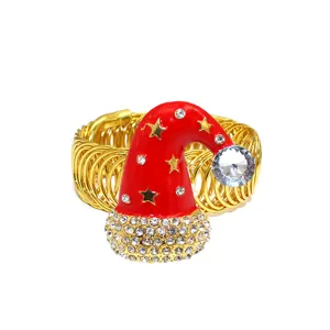 Gold metal spring curtain buckle featuring a red enameled Santa hat with sparkling rhinestones.