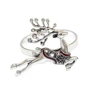 Close-up of vintage silver reindeer napkin ring with rhinestones and red enamel detailing.