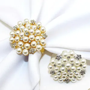 Elegant pearl napkin ring detail showing intricate flower design with sparkling rhinestones.