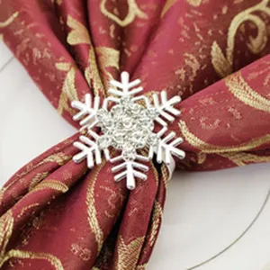 Elegant silver snowflake napkin ring with sparkly rhinestones for Christmas table decor and dining.