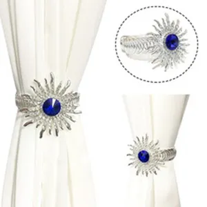 Fermatenda a molla in metallo con strass blu design sole per decorazione della casa chic.