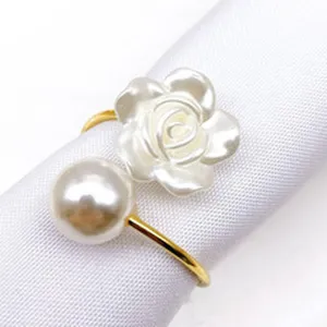 Pearl napkin ring detail showcasing white floral and metallic gold alloy ring design.