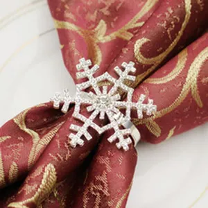Silver rhinestone snowflake napkin ring detail shot, elegant holiday table decor accessory.