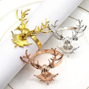 Detail shot of Christmas elk napkin rings, metal deer head napkin holders in gold and silver.