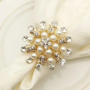 Close-up detail of luxury gold metal pearl and rhinestone napkin ring for table decor.