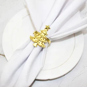 Gold Christmas tree napkin ring detail view, elegant metal table decor for holiday dinner parties.