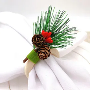Detailed view of a Christmas napkin ring featuring pine needles, pinecones, and red berries.