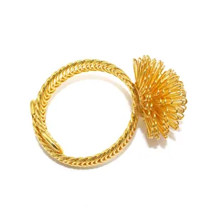 Golden metal curtain tieback detail, creative wire flower ball design, elastic ring spring clip.