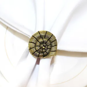 Golden nautilus shell metal napkin ring, ocean theme table decor detail display