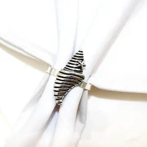 Detailed shot of coastal style metal napkin ring featuring shell and starfish design for table.