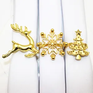 Gold Christmas napkin rings set featuring reindeer snowflake and tree designs for holiday table.