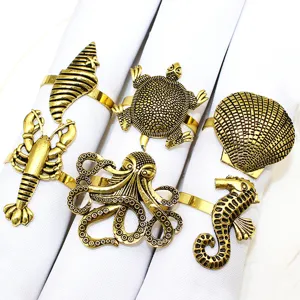 Gold metal nautical napkin rings set featuring ocean animal shapes like lobster and octopus.
