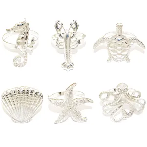 Ocean theme metal napkin rings set of 6 featuring seahorse, lobster, turtle, and shell.