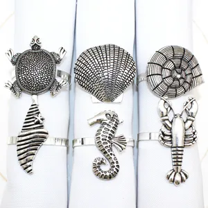 Set of 6 ocean theme metal napkin rings featuring turtle shell seahorse lobster designs.