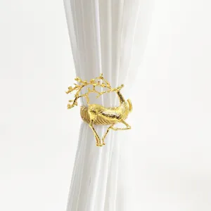 Detailed close-up of a luxury golden deer curtain tieback showcasing fine metal spring texture.