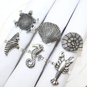 Metal ocean theme napkin rings close-up, lobster and seashell details for table decor