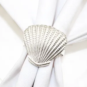 Silver seashell napkin ring detail shot, elegant coastal table decor for weddings and parties.