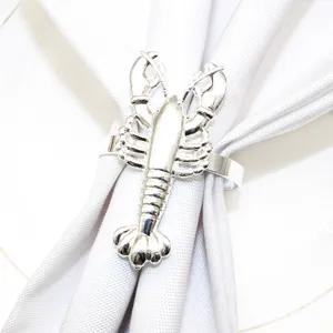 Silver lobster napkin ring detail shot, elegant metal dinner table decor for party.