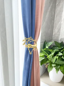 Gold deer curtain tieback detail, elegant metal spring buckle for home decor and window styling.
