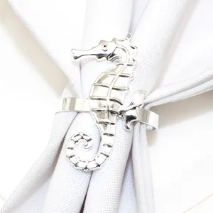 Silver seahorse napkin ring detail shot, elegant metal design for dining table decor.
