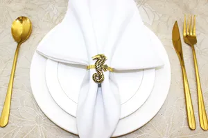 Detail shot of the gold seahorse napkin ring showcasing intricate texture and elegant table decor.