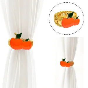 Fermatenda a molla in metallo dorato con decorazione di zucca arancione per finestre di casa.