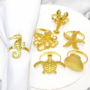 Set of 6 gold ocean themed napkin rings featuring sea creatures like starfish and turtle.