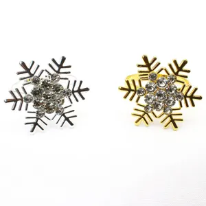 Detailed close-up of rhinestone snowflake napkin rings, elegant table decor for Christmas.