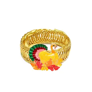 Close-up detail of the colorful turkey and maple leaf pendant on the gold spring curtain tieback.