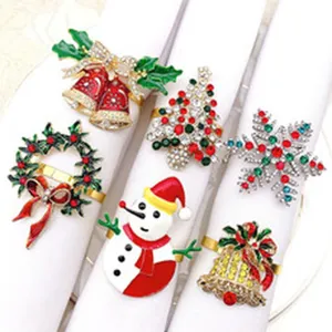 Close-up detail shot of various Christmas rhinestone napkin rings, featuring festive designs.