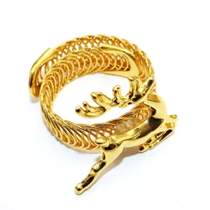 Close-up detail of the golden Christmas deer curtain buckle, showing the exquisite metallic spring.