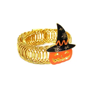 Detail view of Halloween gold metal spring curtain tieback with enamel pumpkin witch hat.