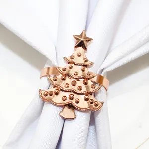 Rose gold Christmas tree napkin ring detail view, elegant holiday table decor buckle holder.