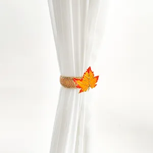 Detail view of metal maple leaf curtain tieback spring buckle showing exquisite design