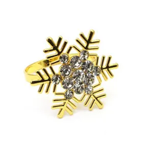 Detailed shot of the elegant gold snowflake napkin ring, featuring sparkling clear crystal rhinestones.
