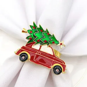 Metal Christmas tree car napkin ring with colorful rhinestones, detail view on cloth.