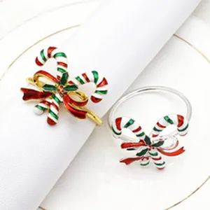 Detail shot of Christmas candy cane napkin rings in gold and silver enamel finish.