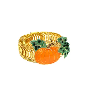 Gold metal spring curtain tieback with orange enamel pumpkin and rhinestone leaves.