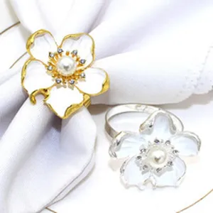Detail shot of exquisite flower pearl napkin ring, alloy metal holder for table decor.