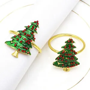 Gold metal Christmas tree napkin ring with green enamel and red rhinestones for table decor.