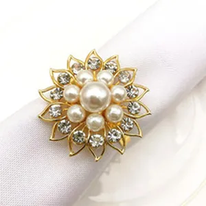 Detailed closeup of a gold alloy sunflower napkin ring decorated with pearls and rhinestones.