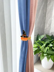 Detailed view of Halloween pumpkin curtain tieback with elastic metal rope for autumn home decor.