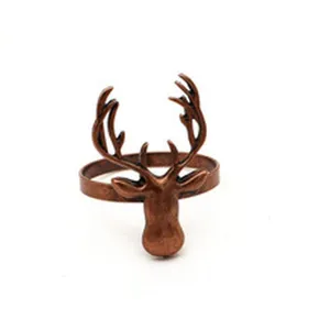 Detailed shot of vintage copper Christmas elk napkin ring, metal deer napkin buckle decor.