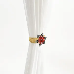 Christmas red crystal snowflake curtain tieback close-up, gold spring band home decor detail.
