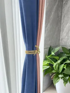 Gold deer curtain tieback detail shot, metal spring band for modern home drapery decor.