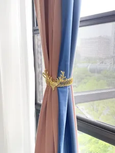 Close-up detail of the metal deer head curtain tieback buckle showcasing fine texture and design.